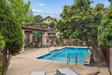 swimming pool view with a seating space