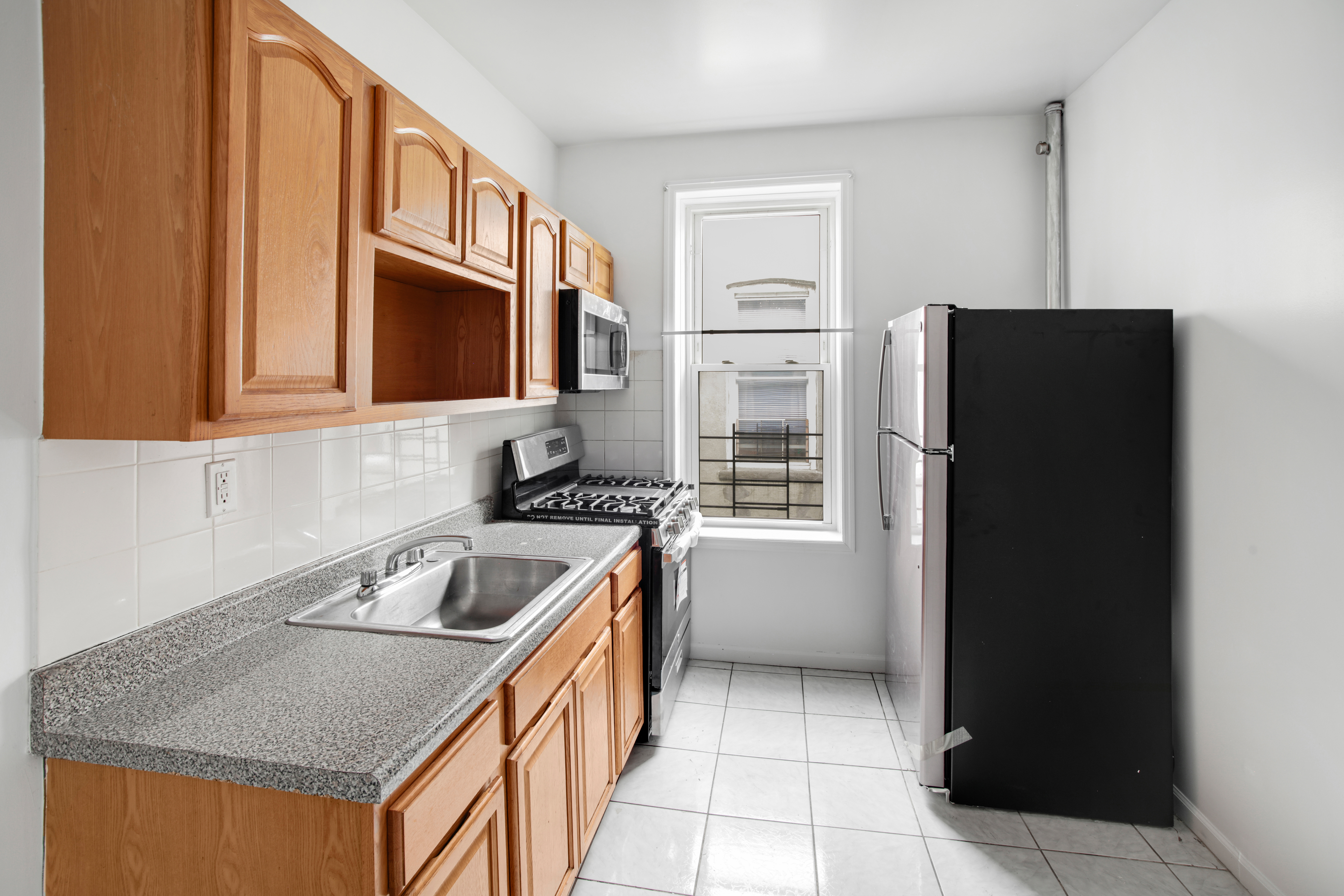 a kitchen that has a sink a refrigerator and a sink