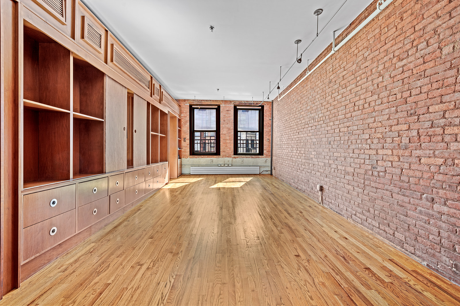 130 Watts Street, Unit 5N Manhattan, NY 10013 - Photo 3 of 11 a view of an empty room with a window and wooden floor
