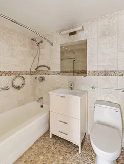 a bathroom with a sink a mirror toilet and bathtub