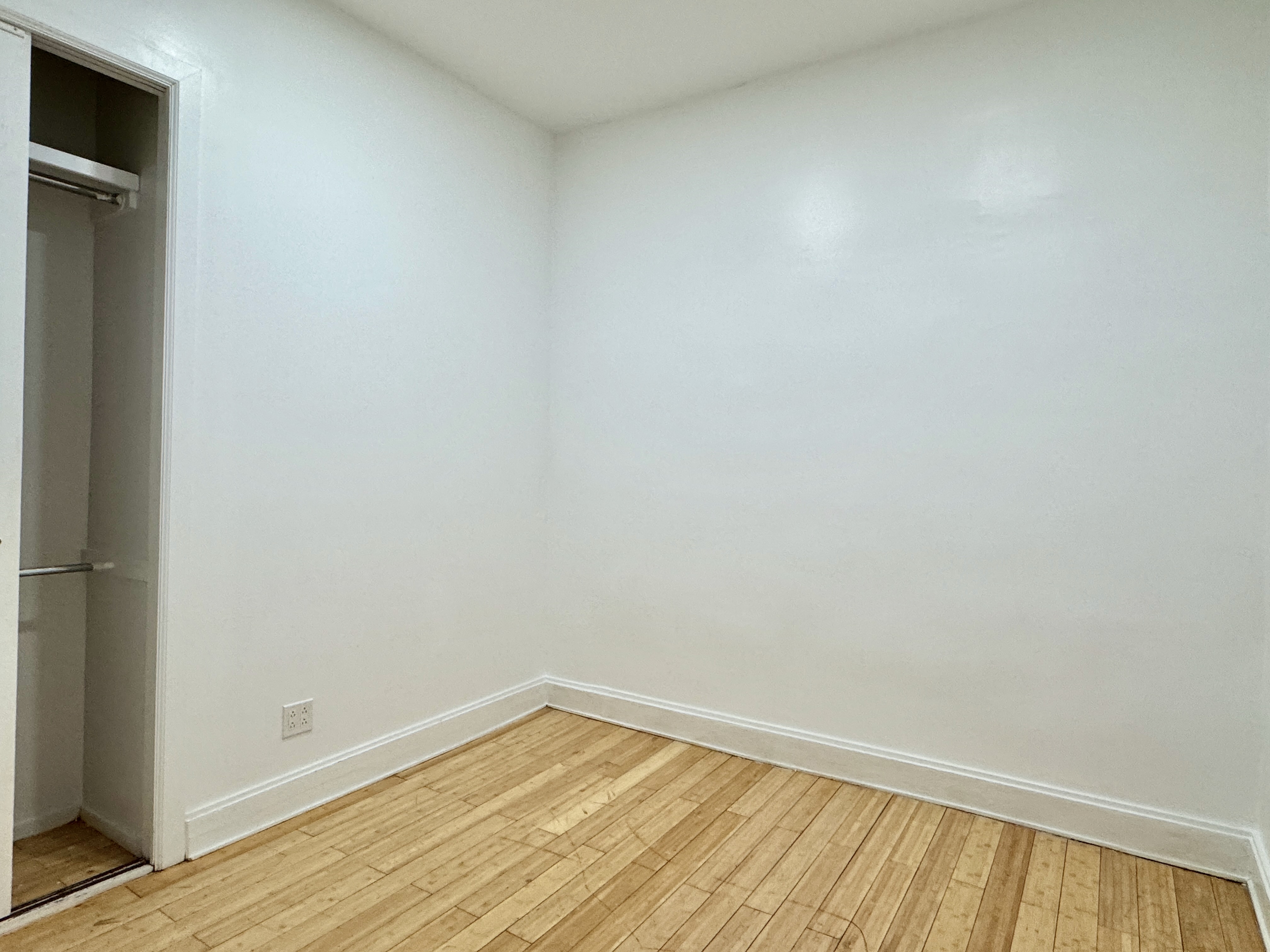 347 Berriman Street, Unit 1 Brooklyn, NY 11208 - Photo 4 of 6 a view of an empty room with wooden floor and a window