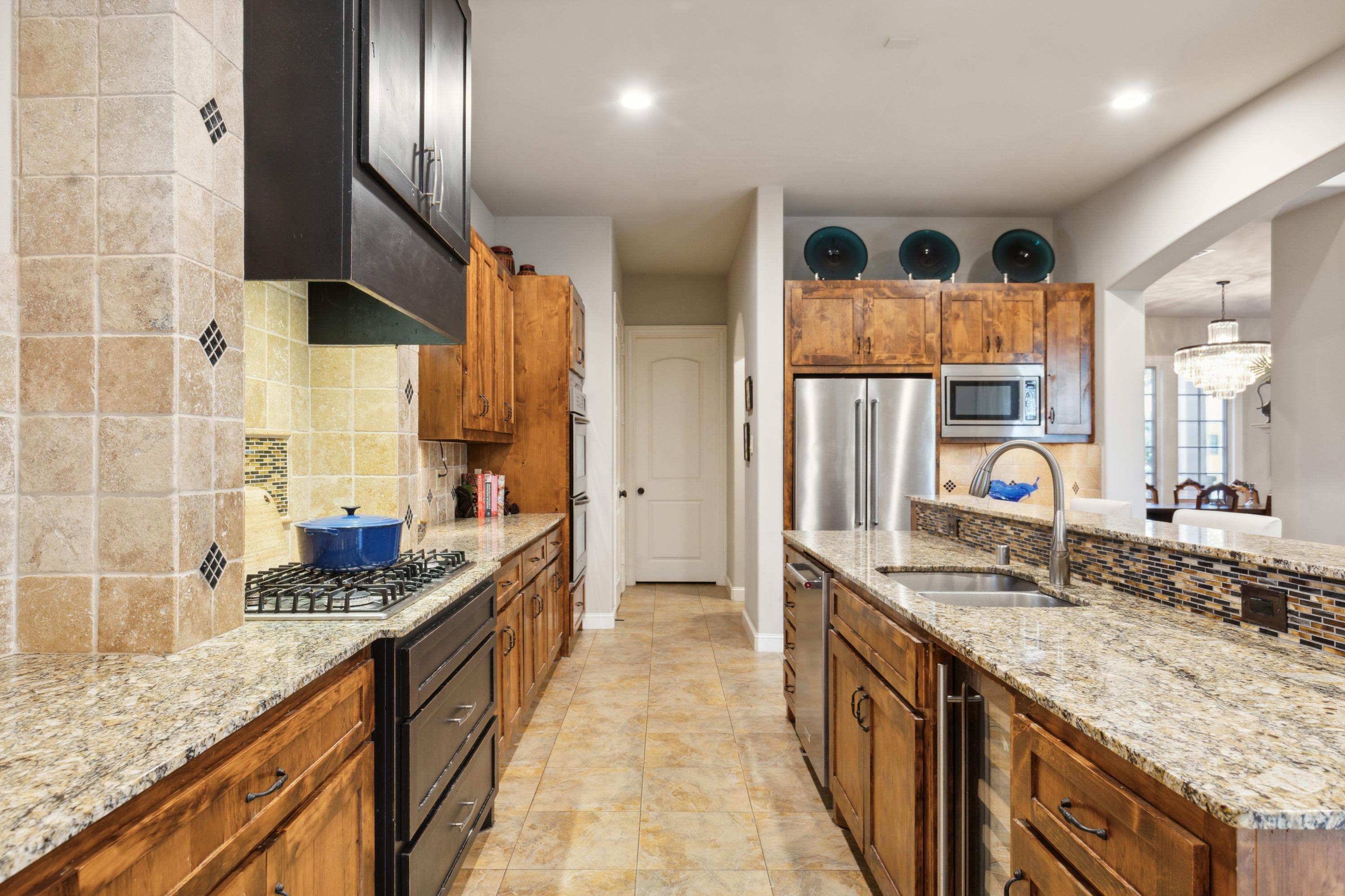 8411 Midway Road Dallas, TX 75209 - Photo 14 of 29 a large kitchen with stainless steel appliances granite countertop a sink and cabinets