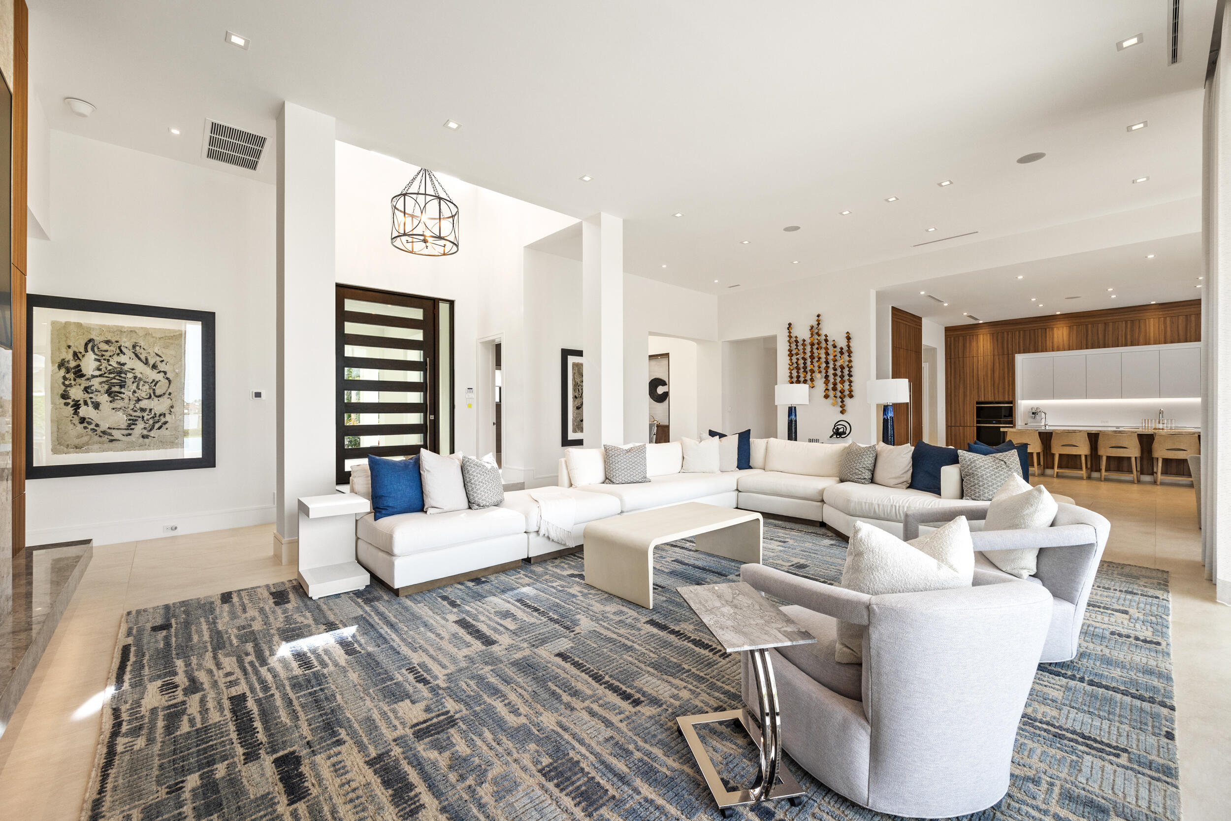 5695 Pennock Point Road Jupiter, FL 33458 - Photo 20 of 77 a living room with couches and kitchen view with wooden floor
