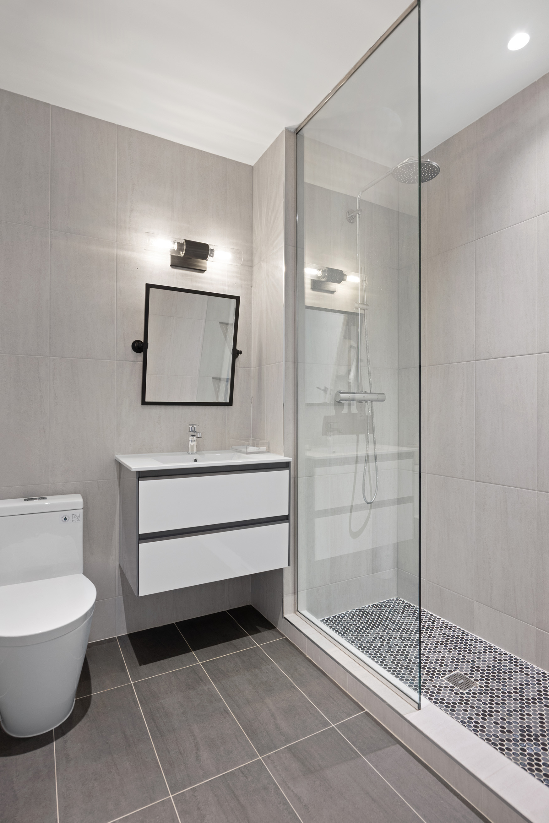 128 West 26th Street, Unit PH Manhattan, NY 10001 - Photo 14 of 21 a bathroom with a toilet a sink and mirror