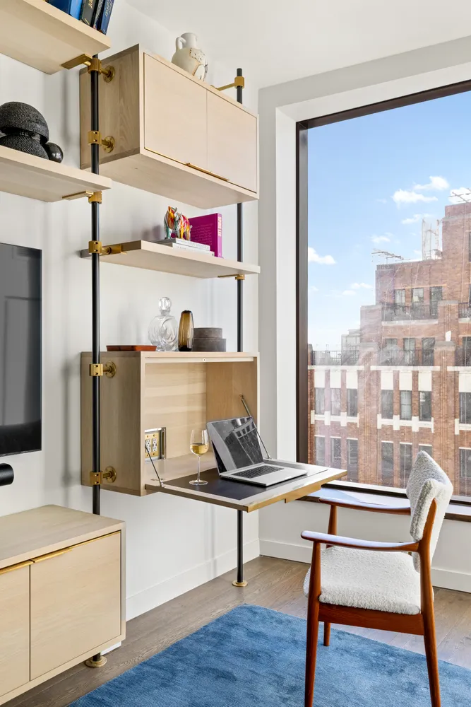 a room with kitchen island stainless steel appliances wooden floor and sink