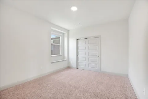 a view of an empty room and closet area