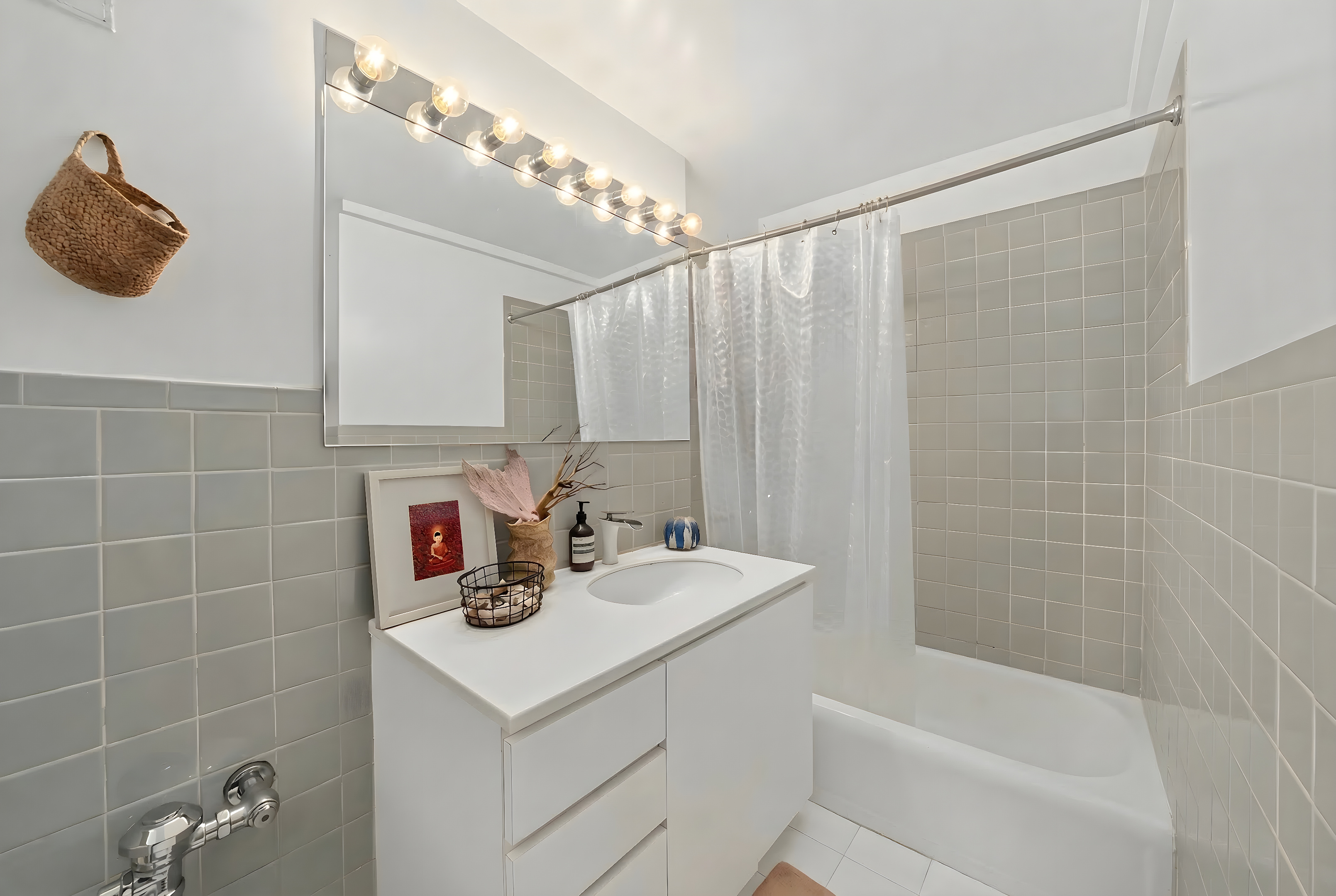 2 Tudor City Place, Unit 15AS Manhattan, NY 10017 - Photo 7 of 17 a bathroom with a sink a tub and a mirror