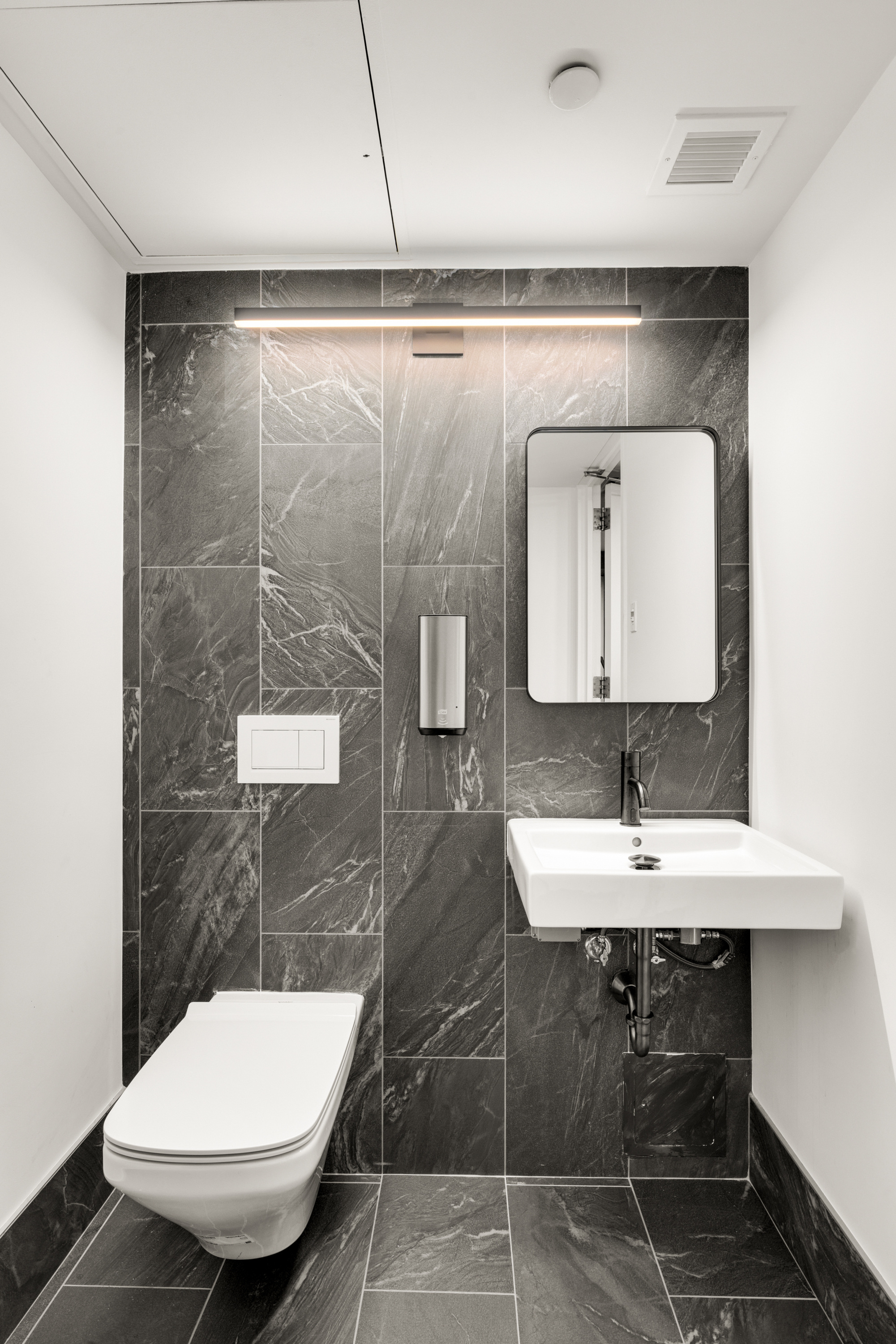 330 Spring Street, Unit 5C Manhattan, NY 10013 - Photo 11 of 18 a bathroom with a toilet sink and mirror