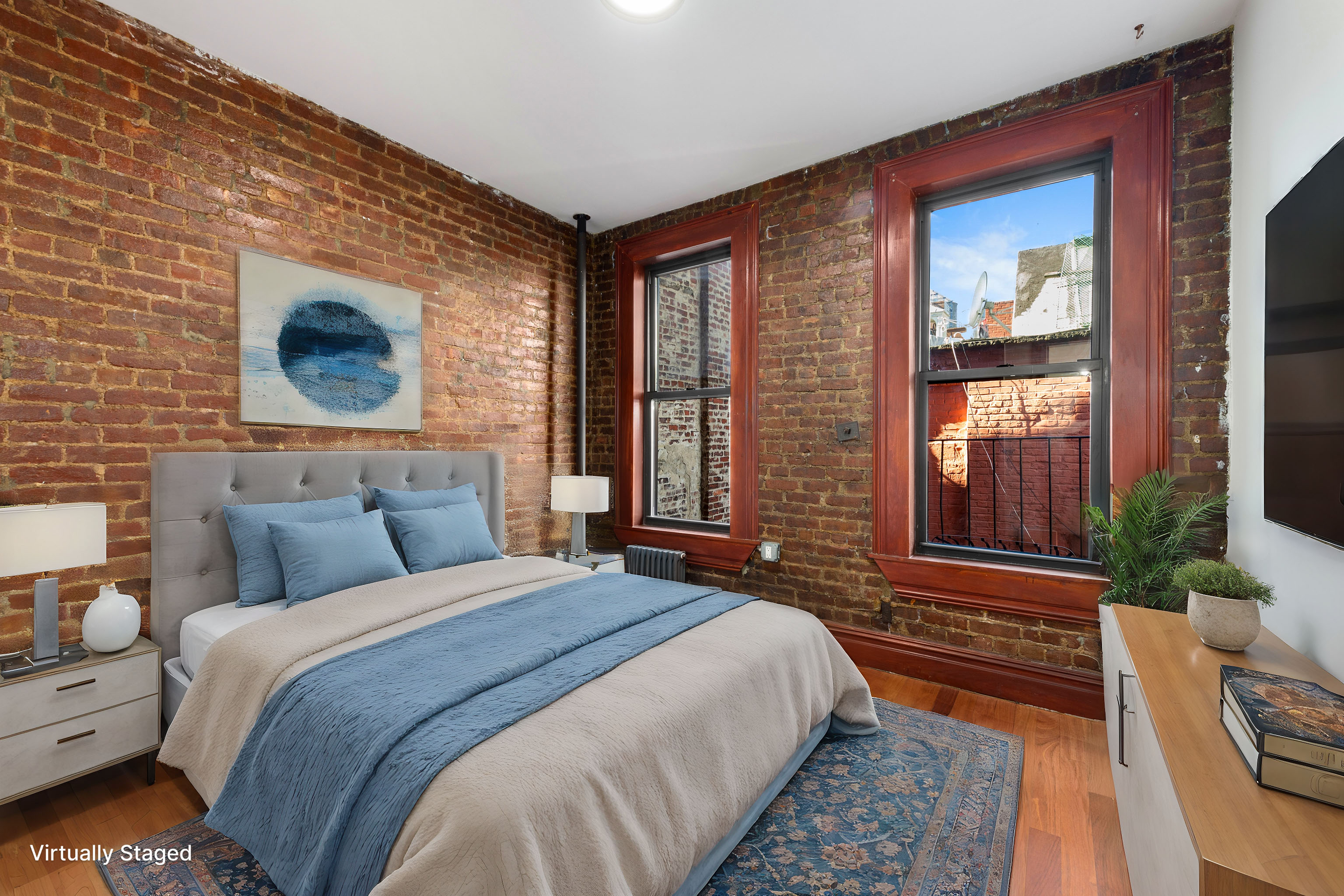 117 Mulberry Street, Unit 14 Manhattan, NY 10013 - Photo 3 of 4 a bedroom with bed and a large window