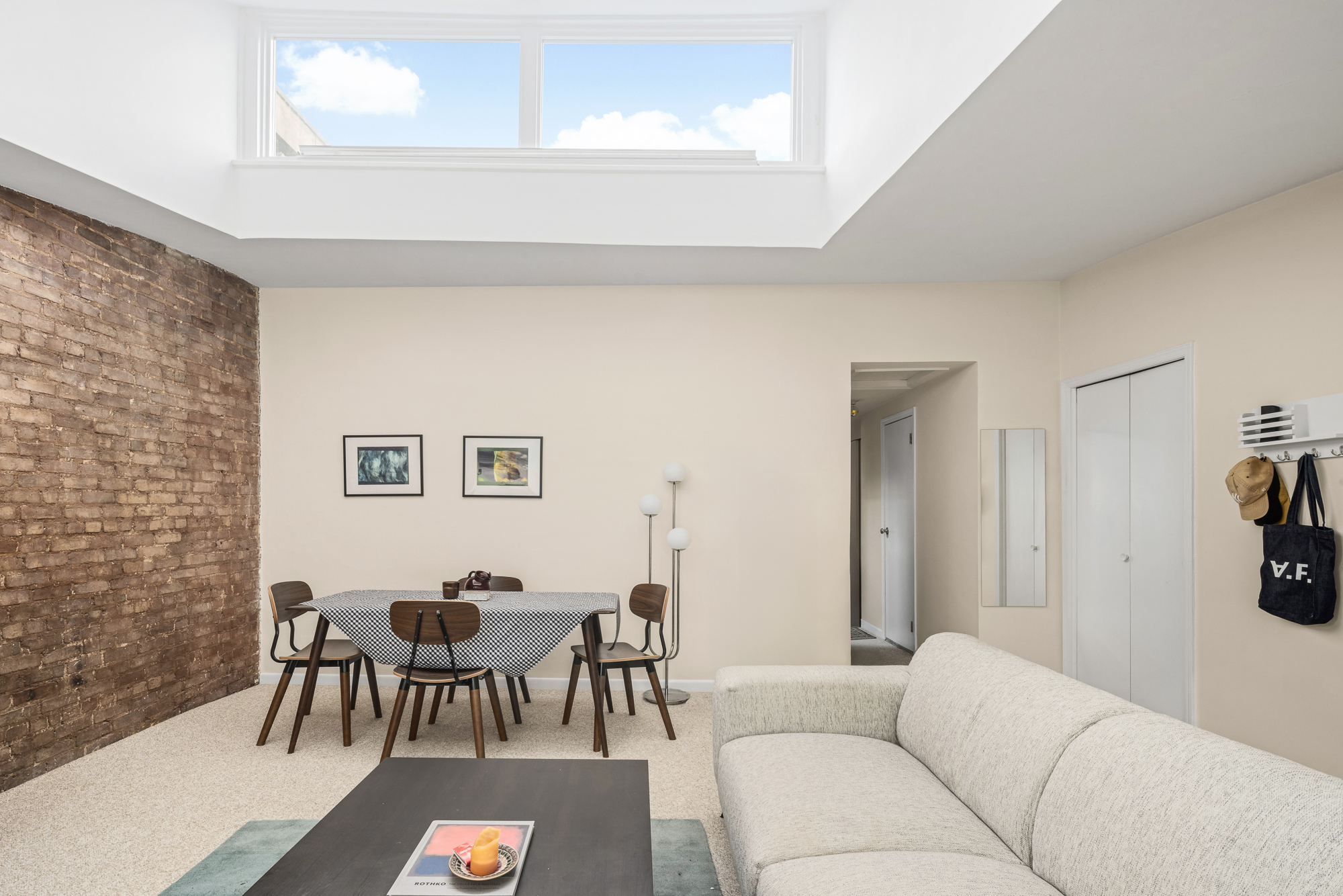 342 West 22nd Street, Unit 3 Manhattan, NY 10011 - Photo 4 of 11 a living room with furniture and a table