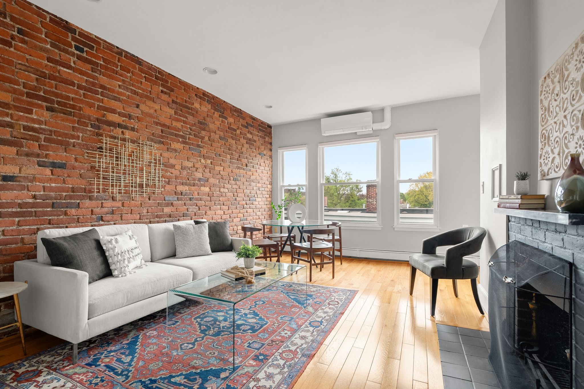 88 Hancock Street, Unit 17 Cambridge, MA 02139 - Photo 1 of 18 a living room with furniture and a fireplace