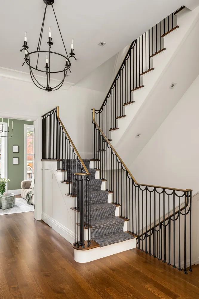 a view of staircase with wooden floor and white walls