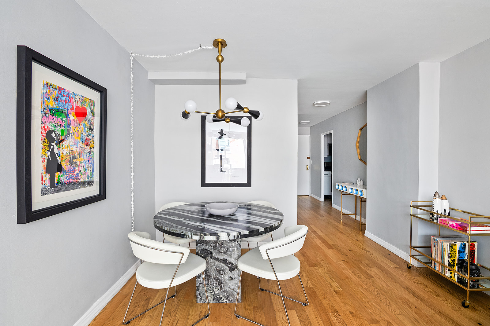 7 East 14th Street, Unit 429 Manhattan, NY 10003 - Photo 2 of 6 a view of a dining room with furniture a chandelier and wooden floor