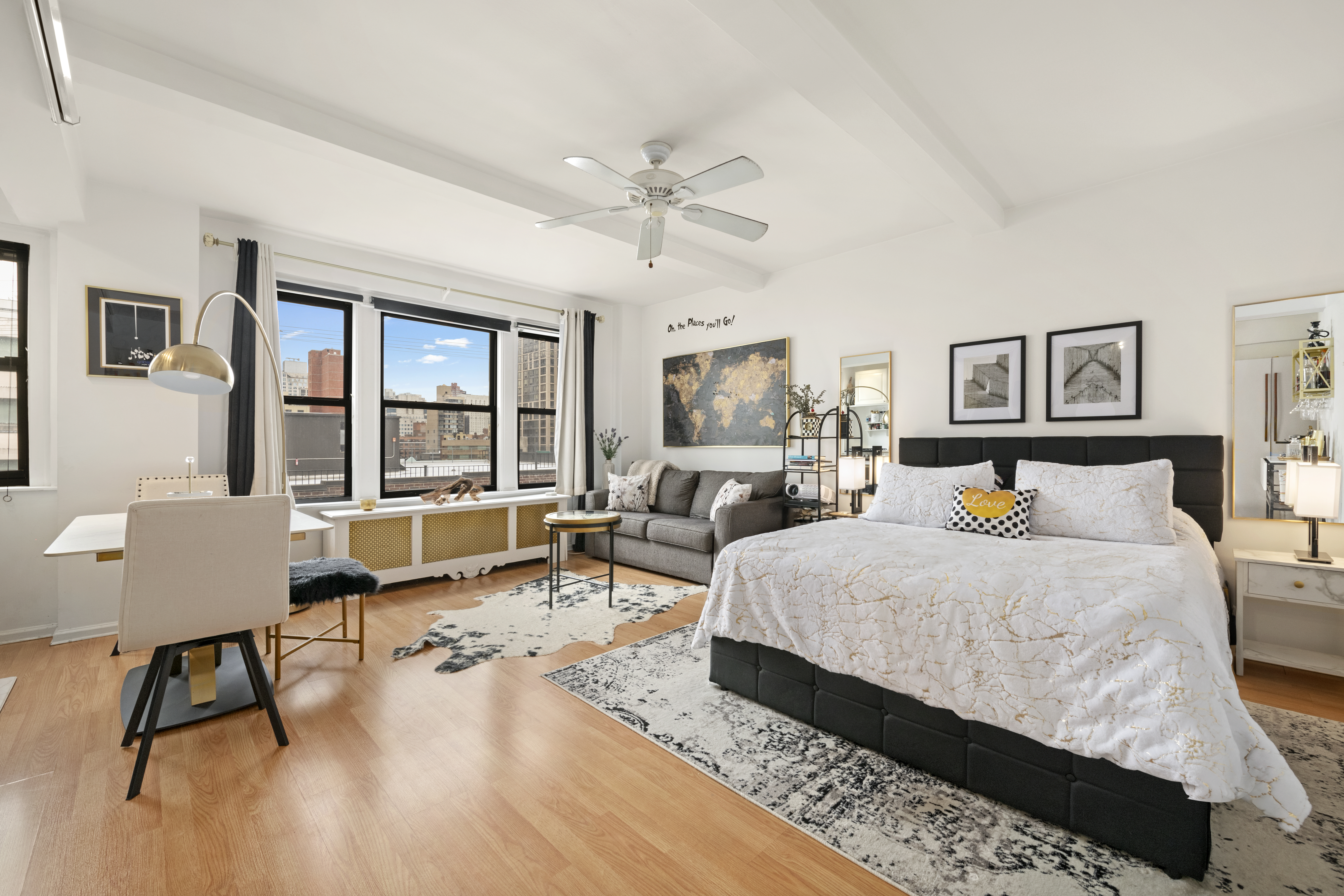339 East 58th Street, Unit 9F Manhattan, NY 10022 - Photo 5 of 9 a spacious bedroom with a bed a table and large windows