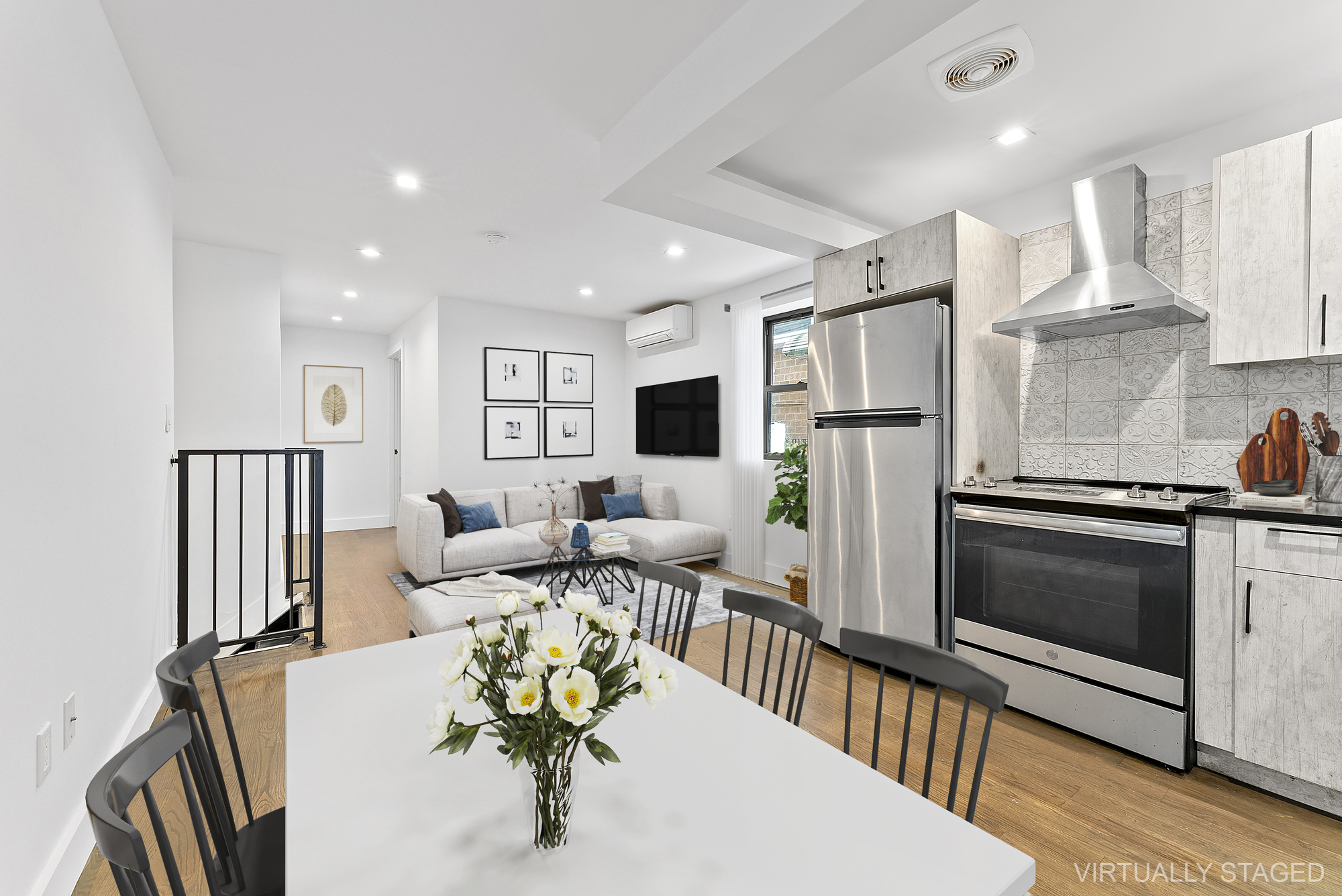 81 Eldert Street, Unit 1 Brooklyn, NY 11207 - Photo 2 of 9 a living room with stainless steel appliances furniture a fireplace and a kitchen view