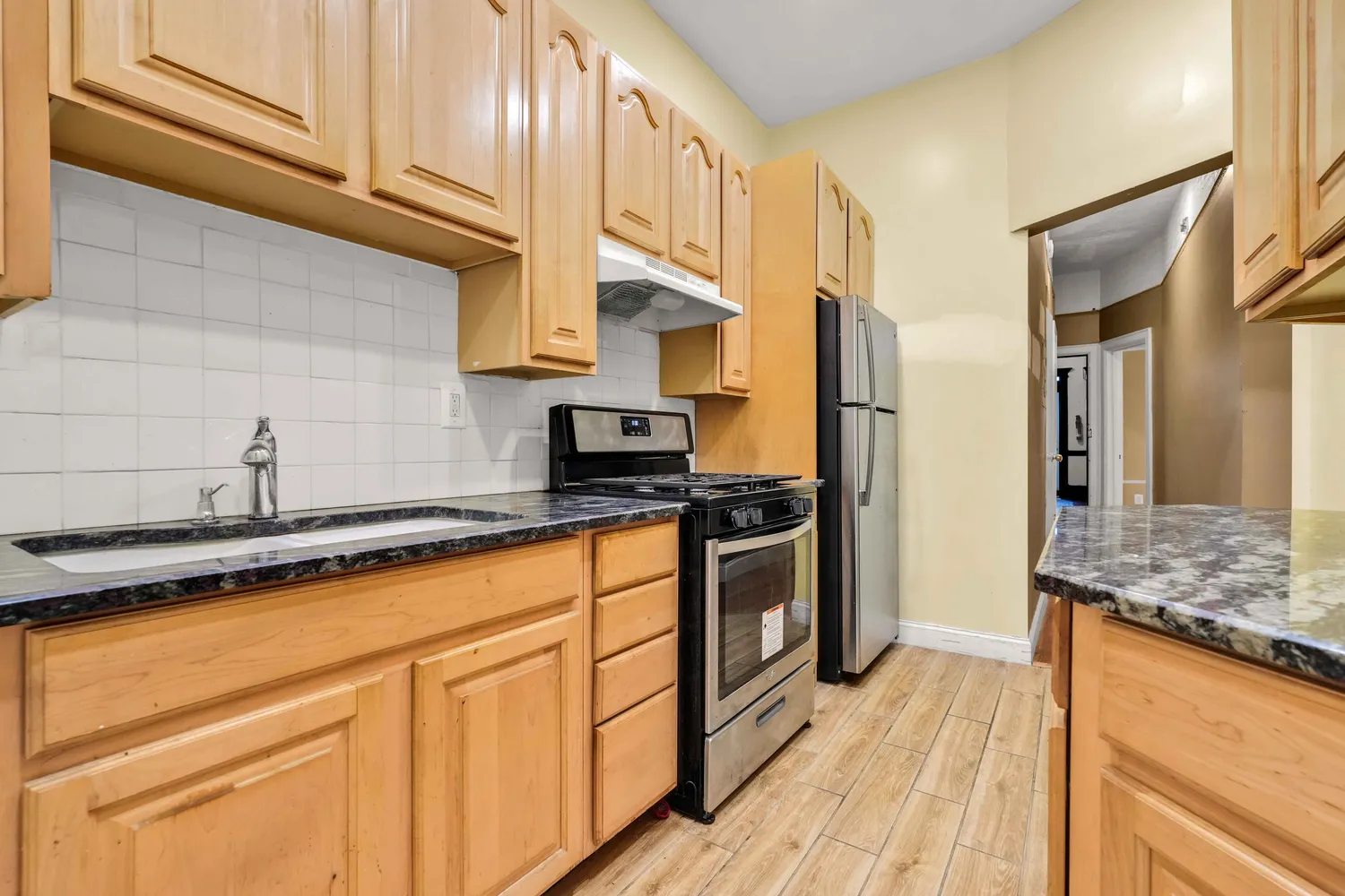 a view of a livingroom with a chandelier fan and windows