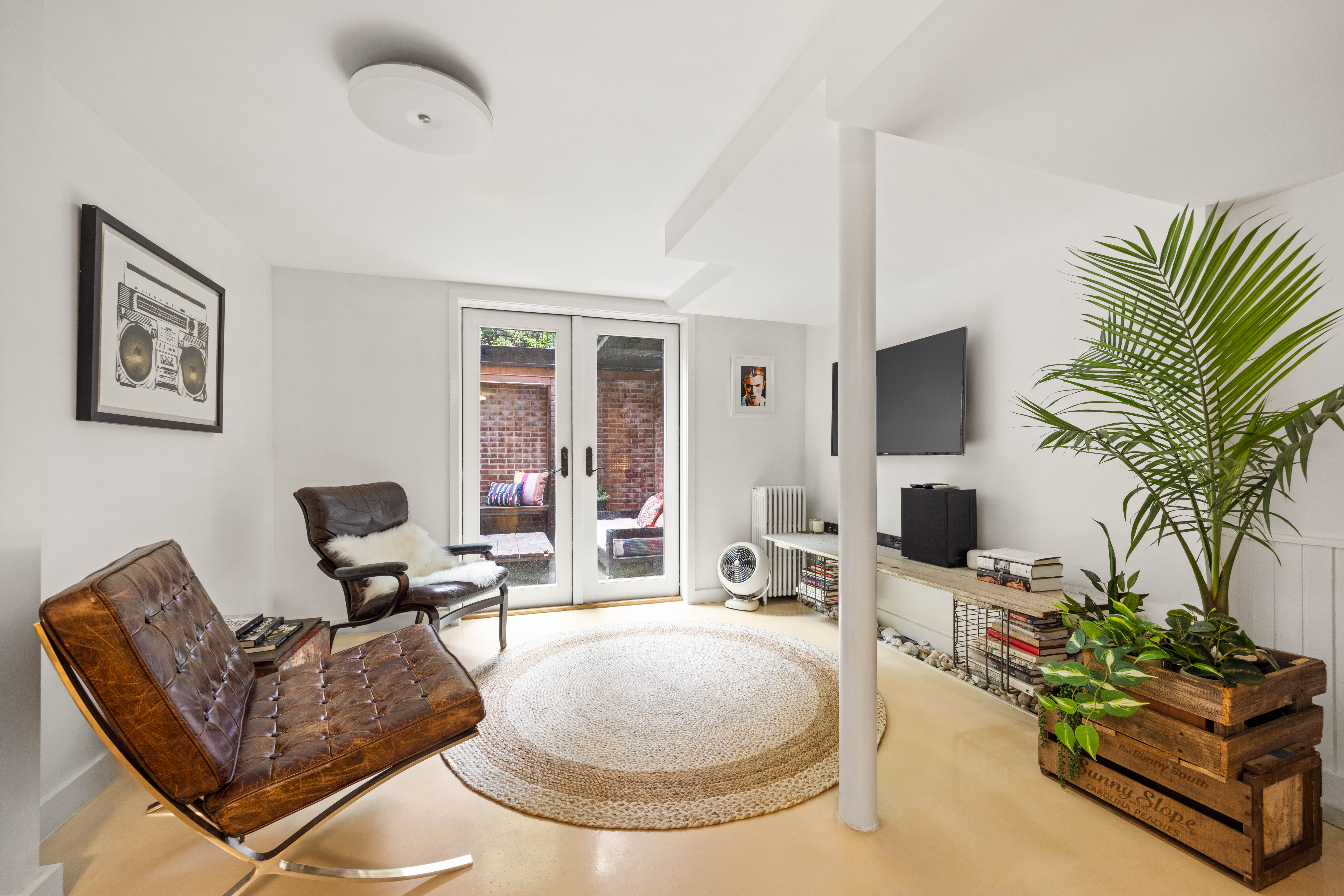 38 7th Avenue, Unit 1 Brooklyn, NY 11217 - Photo 7 of 13 a living room with furniture and a flat screen tv