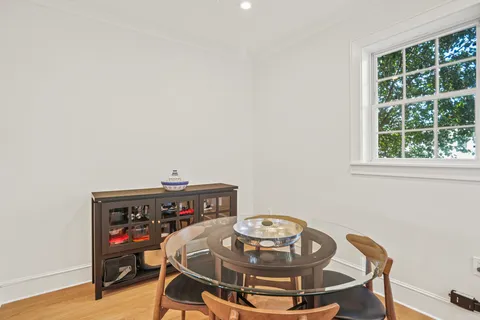 a view of a workspace with furniture and wooden floor
