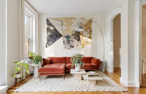 a living room with furniture and a potted plant