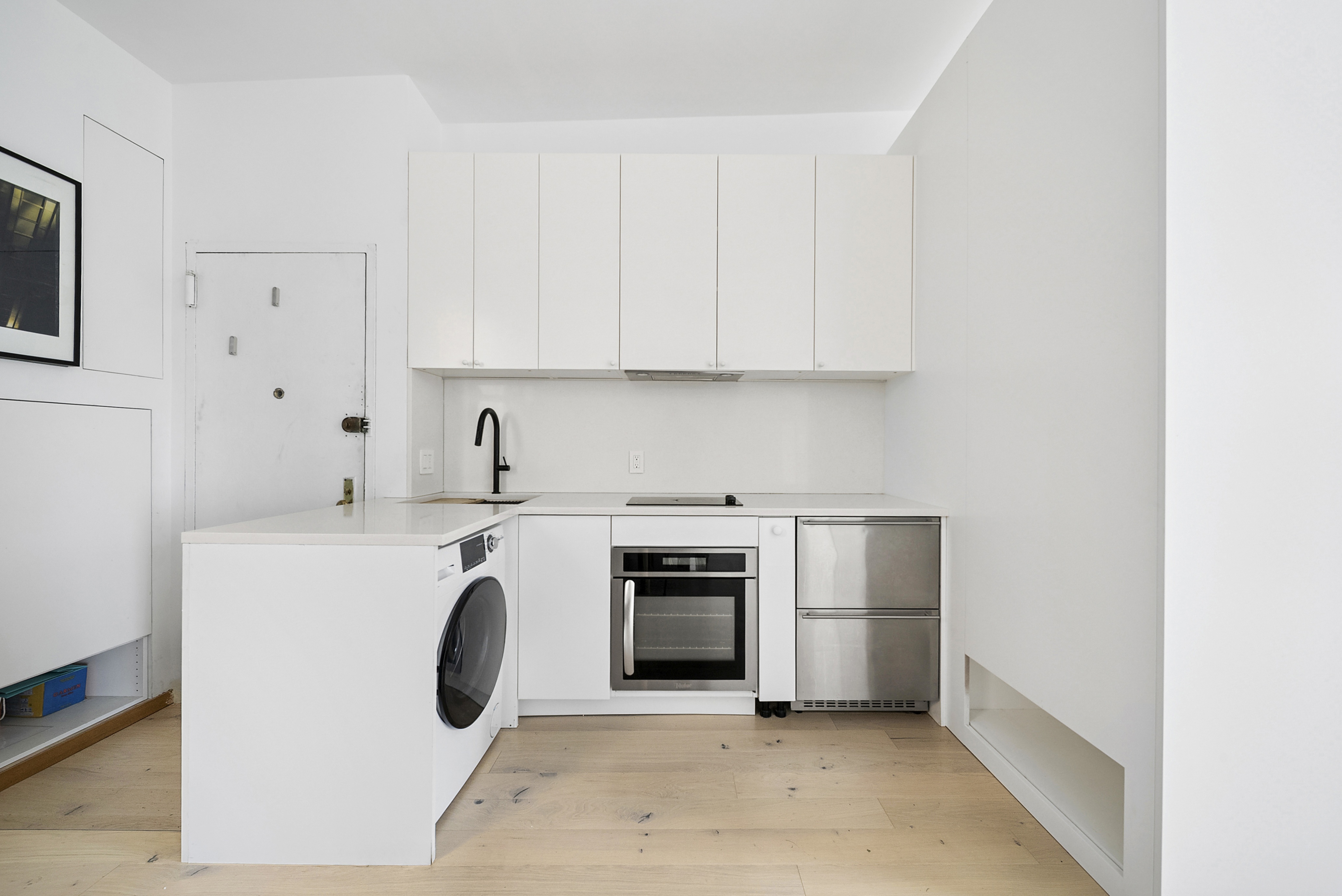 633 East 11th Street, Unit 24 Manhattan, NY 10009 - Photo 6 of 8 a utility room with sink dryer and washer