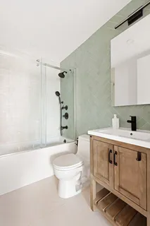 a bathroom with a sink toilet and shower
