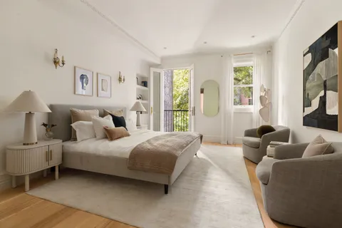 a bedroom with a bed couch and window