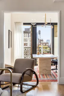 a living room with a bed furniture and a window