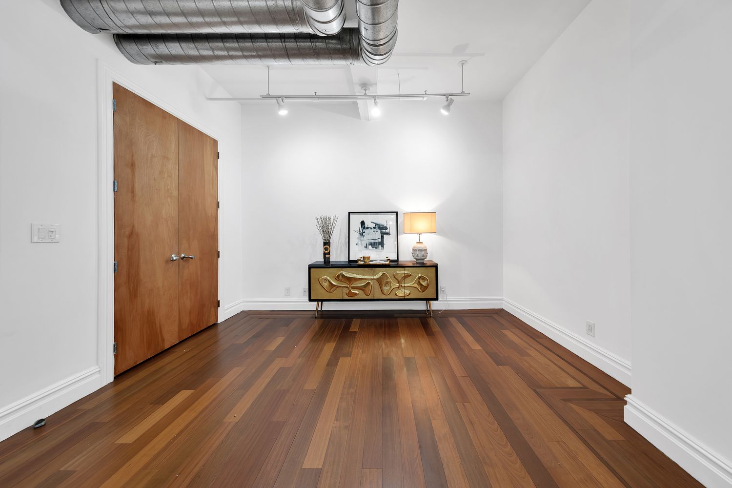 a view of a room with wooden floor