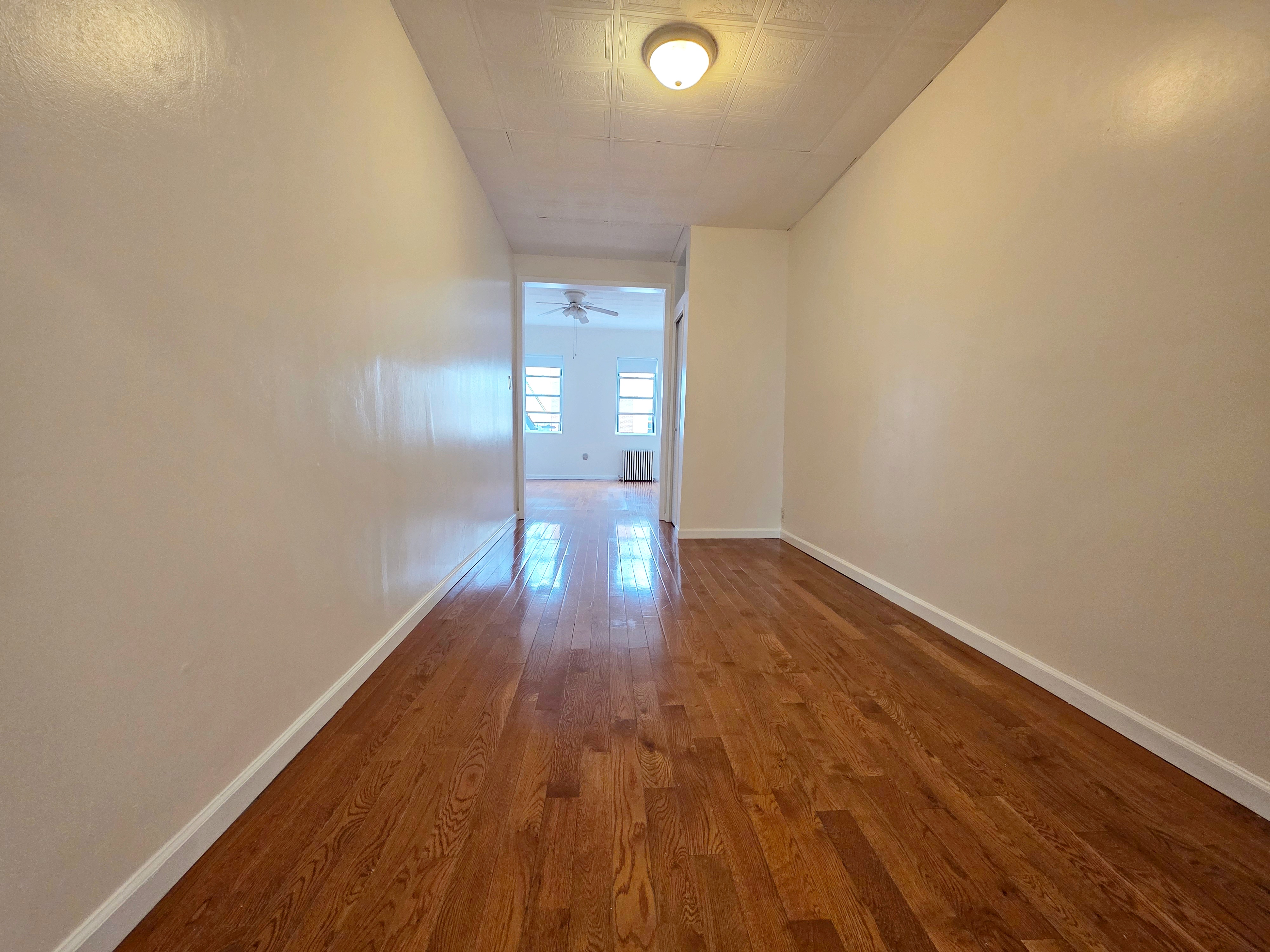 396 Manhattan Avenue, Unit 2L Brooklyn, NY 11211 - Photo 4 of 7 a view of empty room with wooden floor