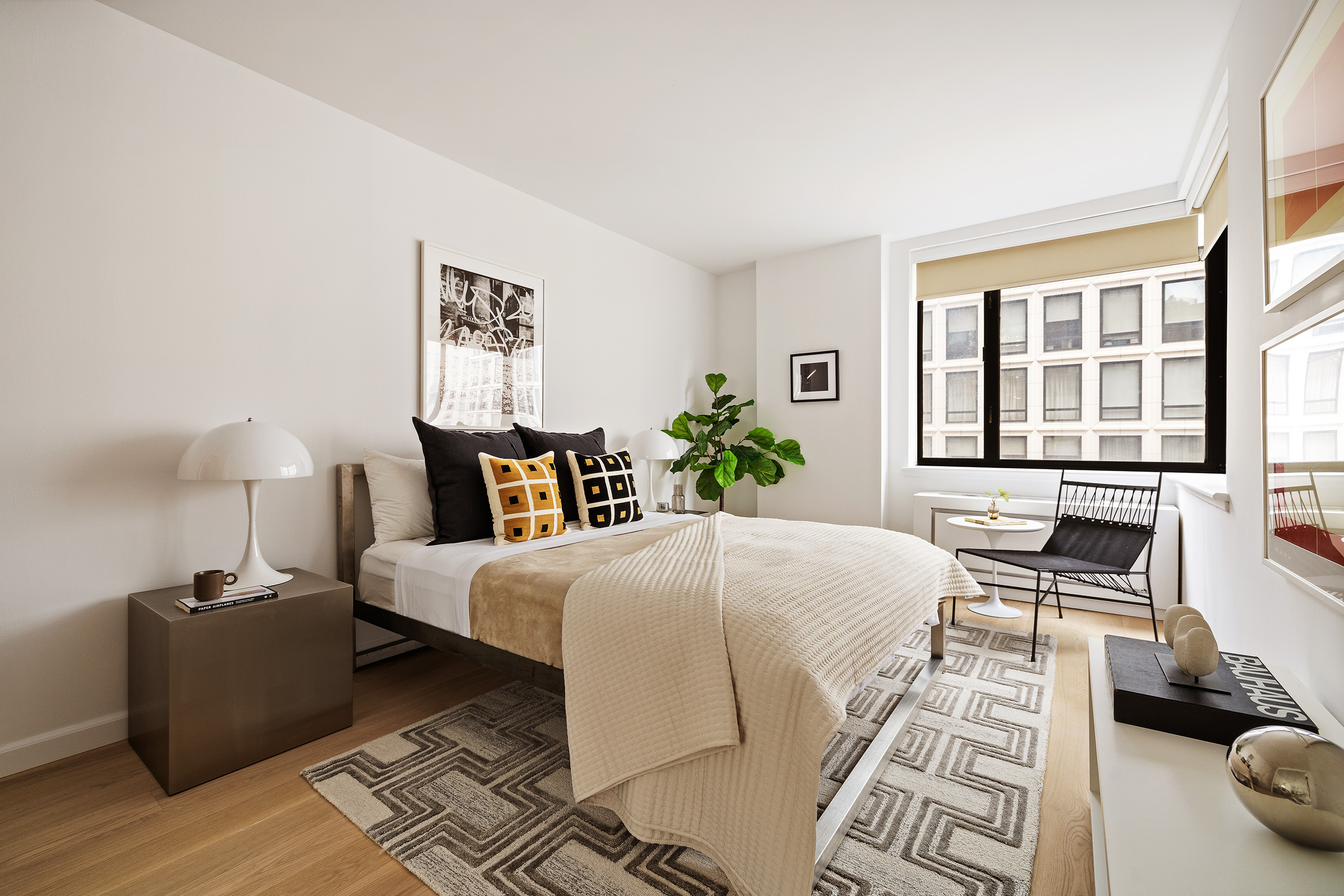 30 West 61st Street, Unit 12G Manhattan, NY 10023 - Photo 5 of 7 a bed room with a bed and a couch