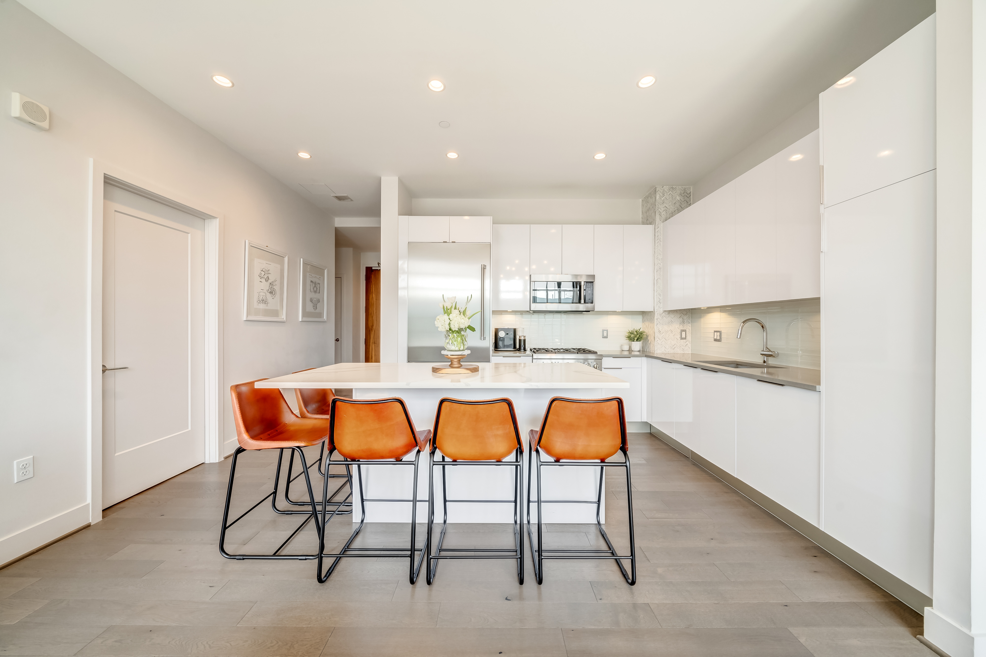 45 Sutton Square Southwest, Unit PH10 Washington, DC 20024 - Photo 13 of 44 a kitchen with stainless steel appliances kitchen island granite countertop a table chairs sink and cabinets
