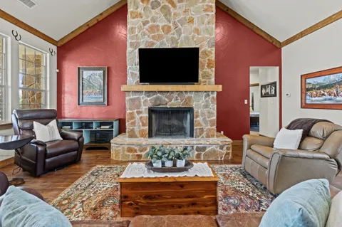 a living room with furniture a flat screen tv and a fireplace