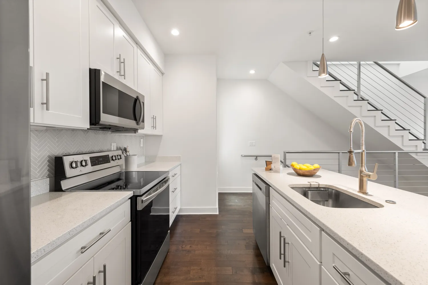 a kitchen with stainless steel appliances a sink a stove top oven a counter space and cabinets