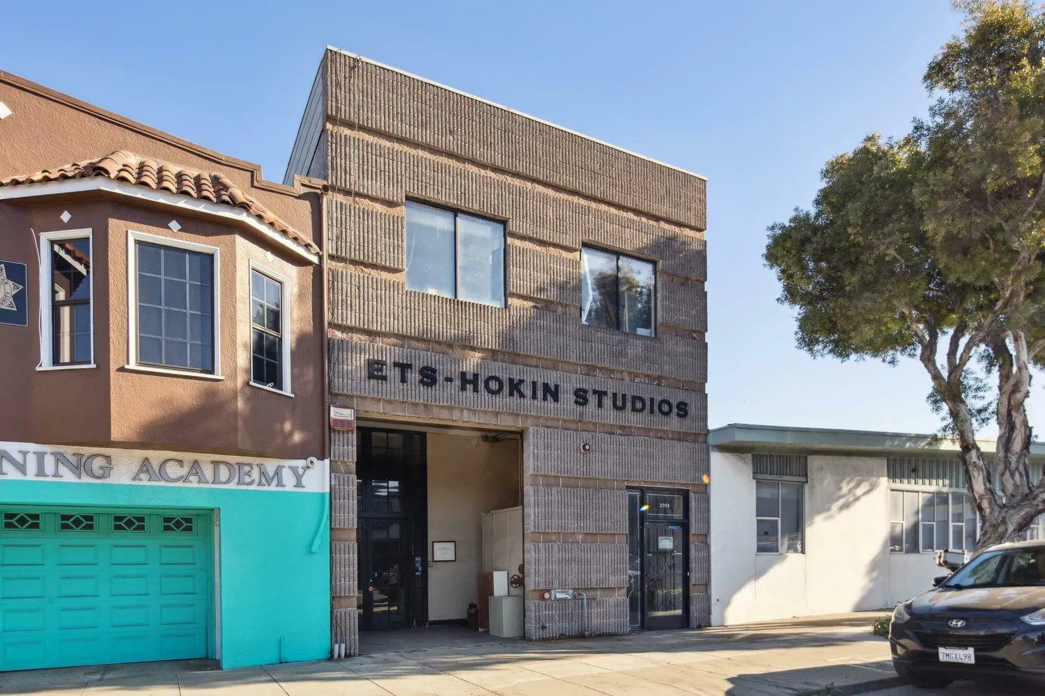 a front view of a building with a garden