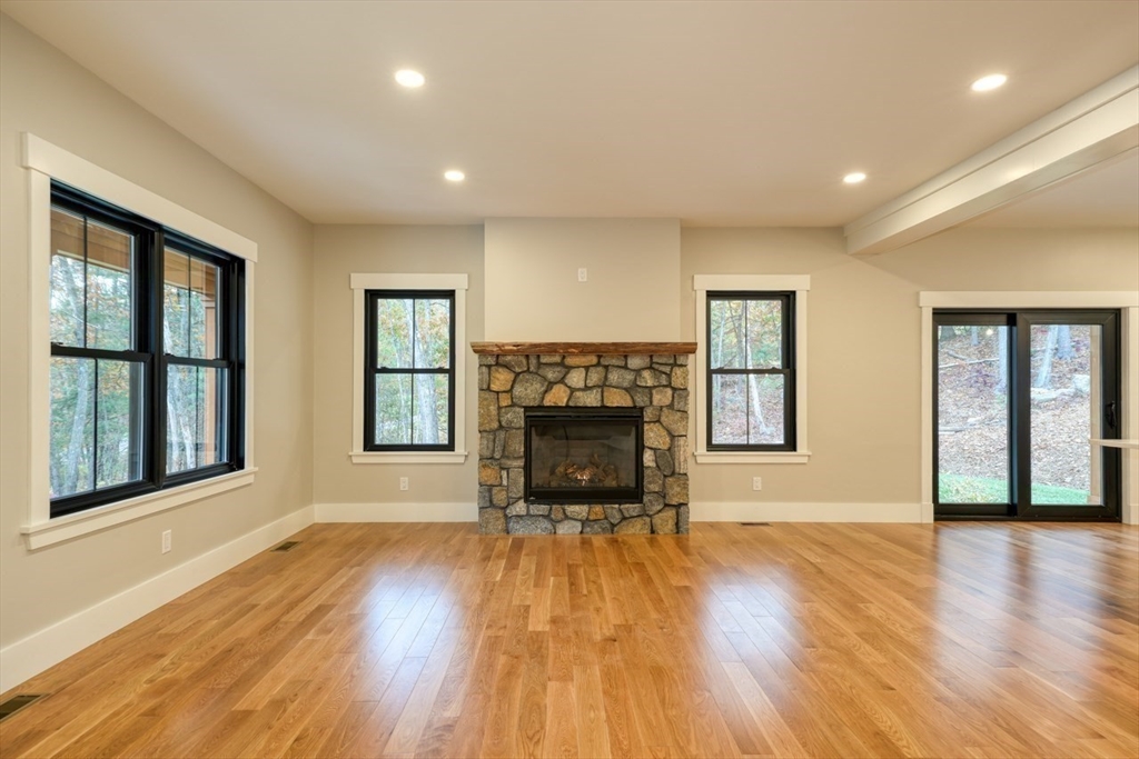 171 Randall Road Berlin, MA 01503 - Photo 4 of 41 a view of an empty room with a fireplace and a window