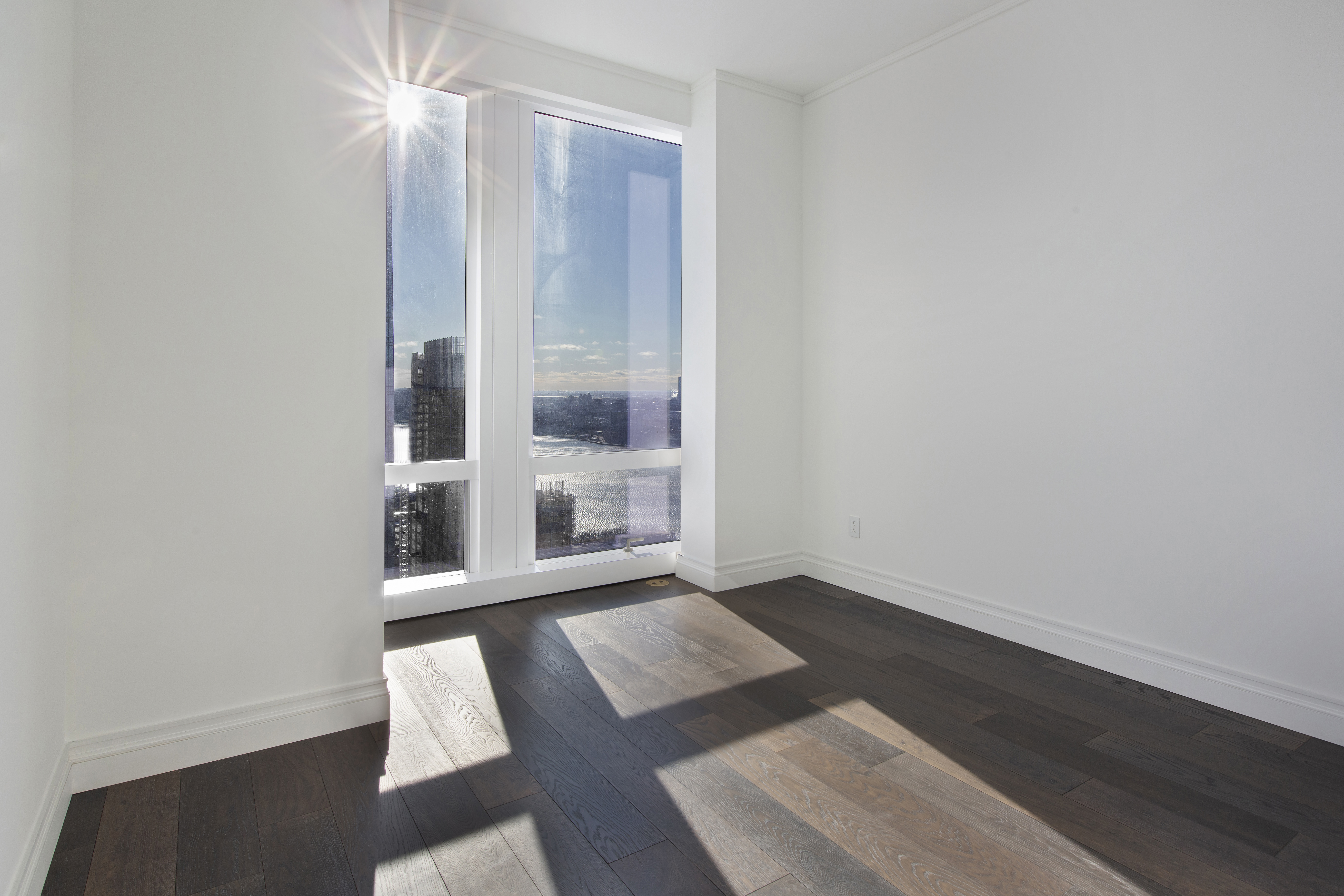 35 Hudson Yards, Unit 5805 Manhattan, NY 10001 - Photo 8 of 19 an empty room with wooden floor and windows