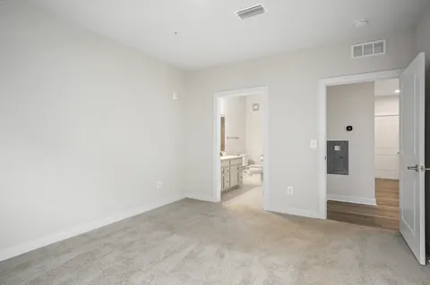 an empty room with a cabinet and mirrors