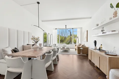 a view of a kitchen with kitchen island granite countertop a sink and a living room view