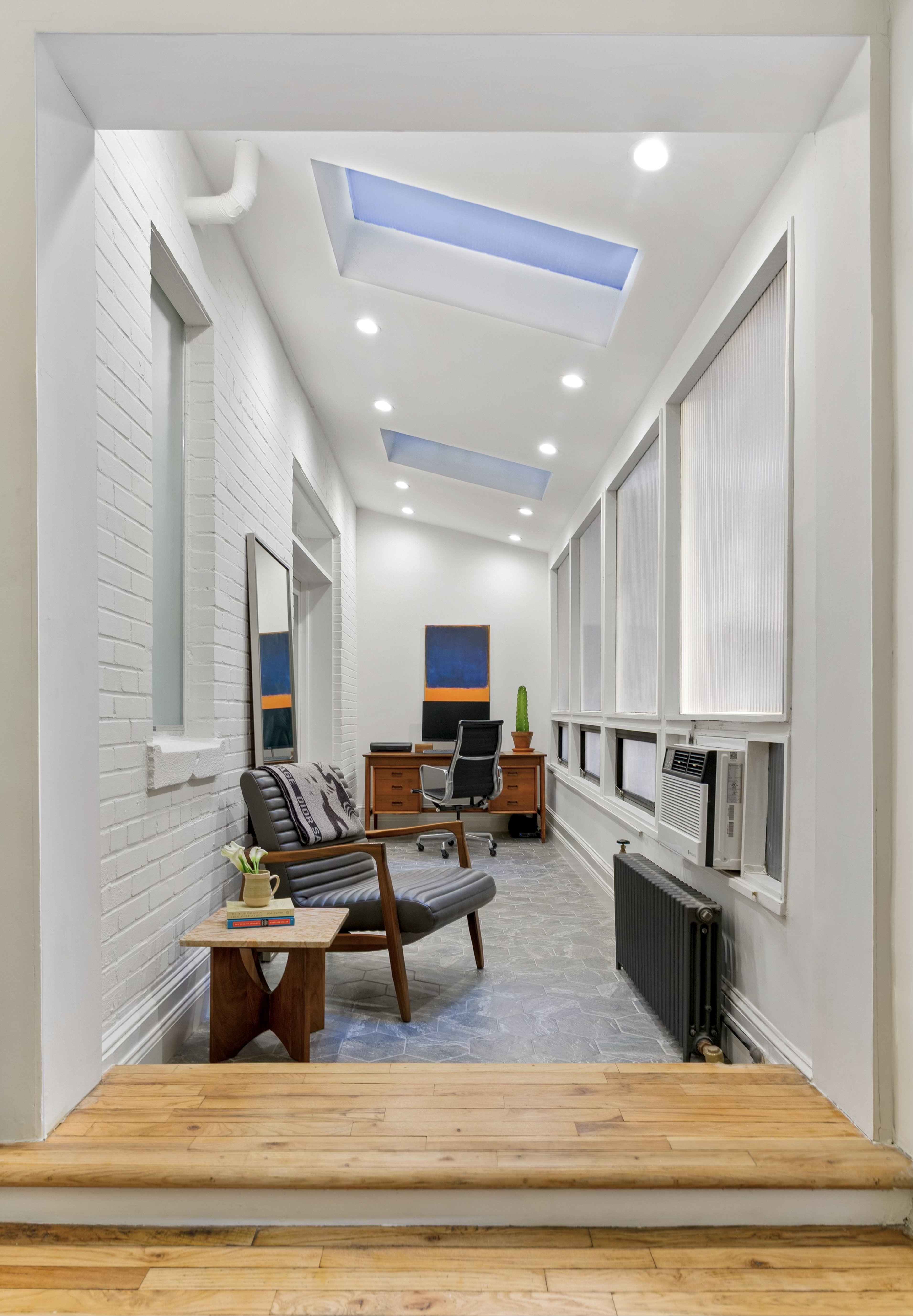 40 West 67th Street, Unit 1A Manhattan, NY 10023 - Photo 6 of 17 a living room with furniture and a flat screen tv