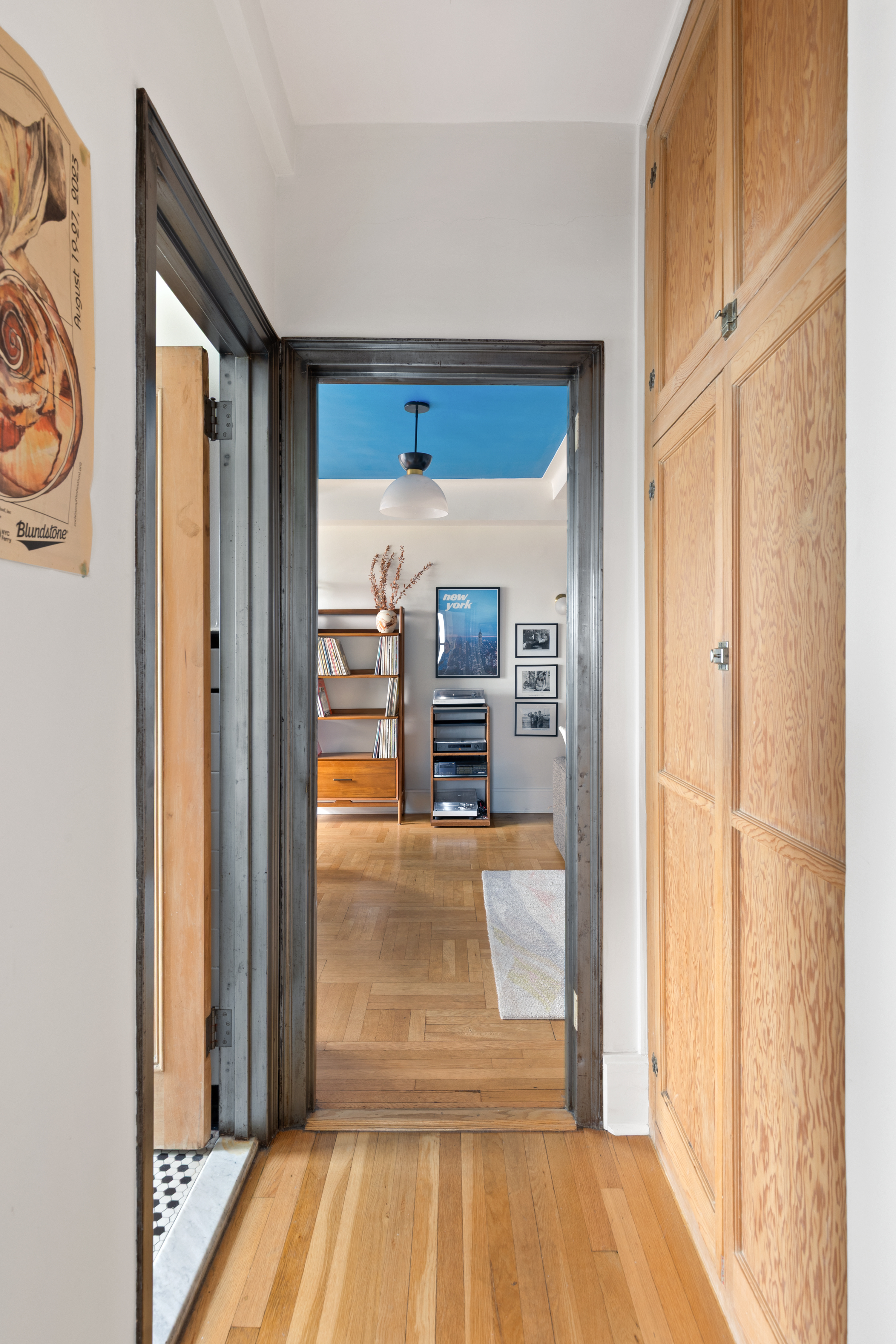 1 Plaza Street West, Unit 12D Brooklyn, NY 11217 - Photo 6 of 12 a view of a hallway with wooden floor and a living room
