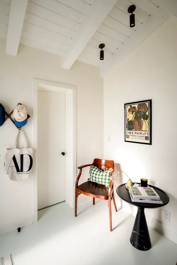 a view of a balcony with two chairs and a potted plant