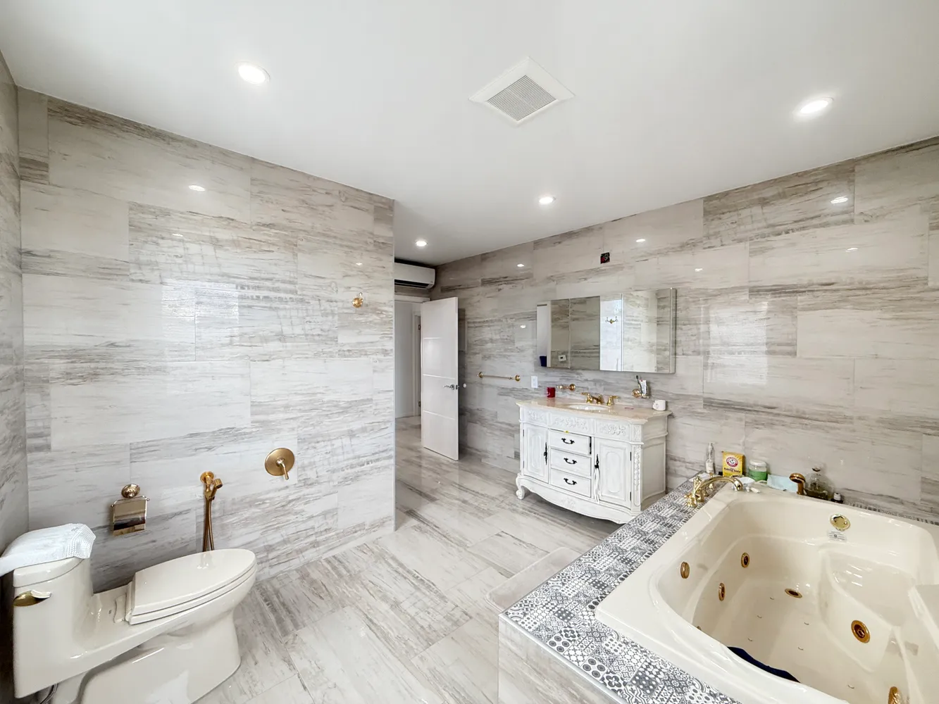a large bathroom with a sink a toilet and bathtub