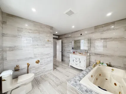 a large bathroom with a sink a toilet and bathtub