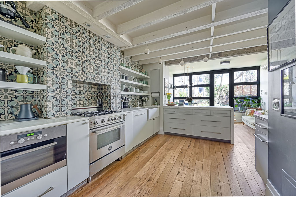 315 15th Street Brooklyn, NY 11215 - Photo 4 of 25 a kitchen with stainless steel appliances wooden floor and a large window