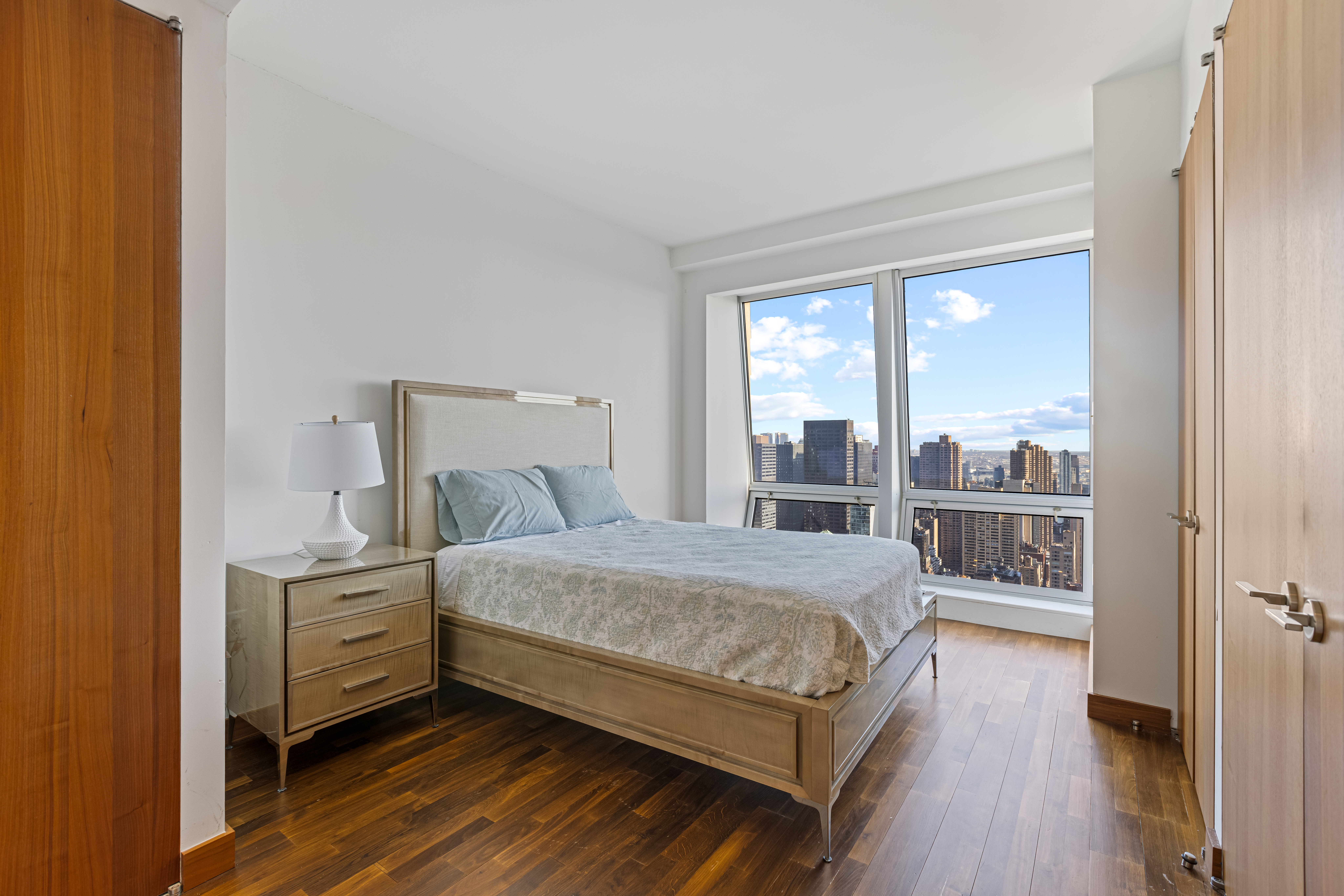400 5th Avenue, Unit 49C Manhattan, NY 10018 - Photo 10 of 21 a bedroom with a bed and wooden floor