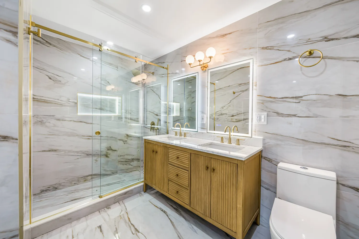 a bathroom with a granite countertop sink a toilet and shower