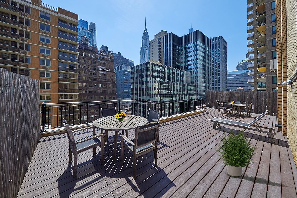 225 East 46th Street, Unit 12G Manhattan, NY 10017 - Photo 15 of 19 a view of a balcony with two chairs and a table