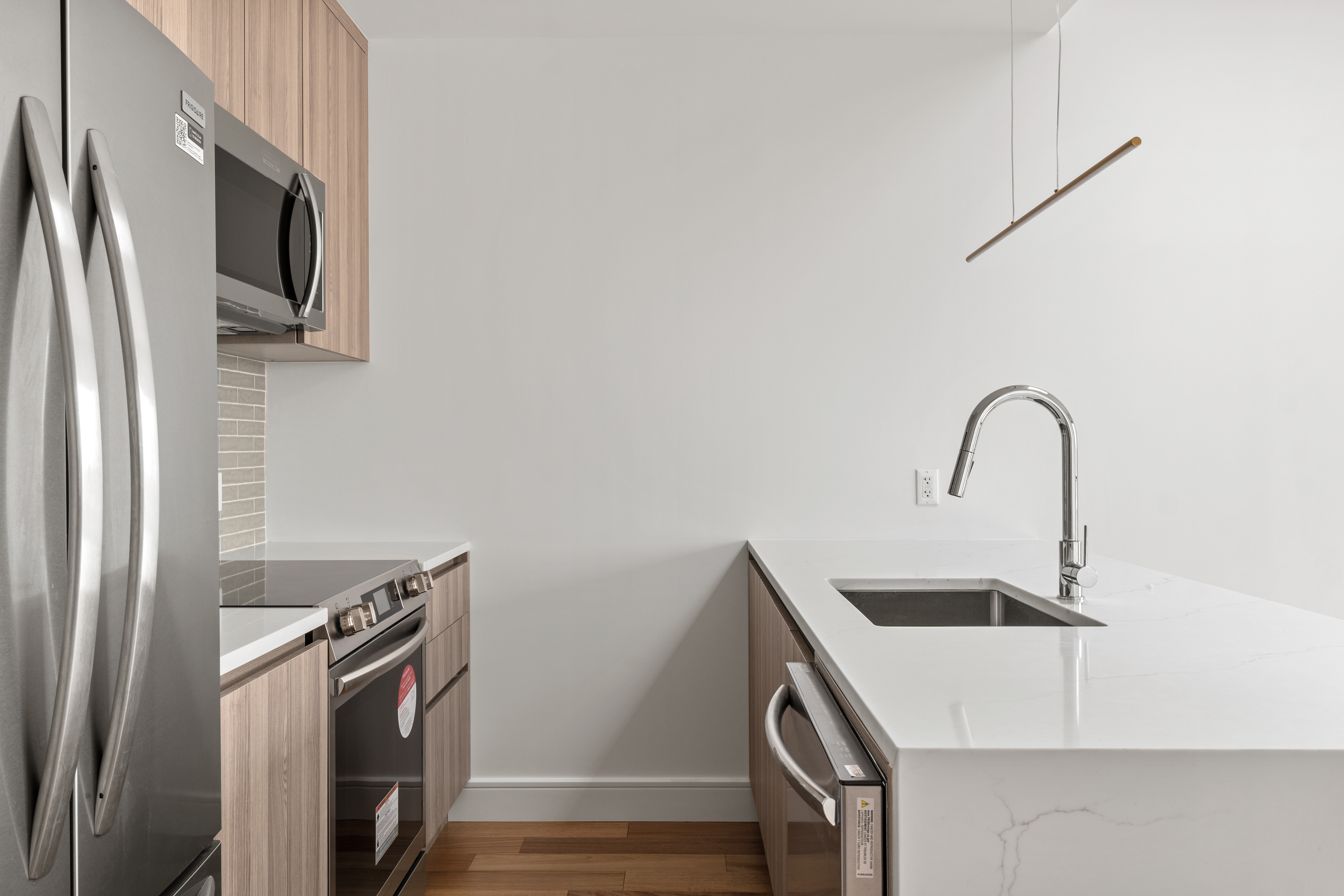 82 Cooper Street, Unit 3A Brooklyn, NY 11207 - Photo 7 of 17 a kitchen with a sink and a refrigerator