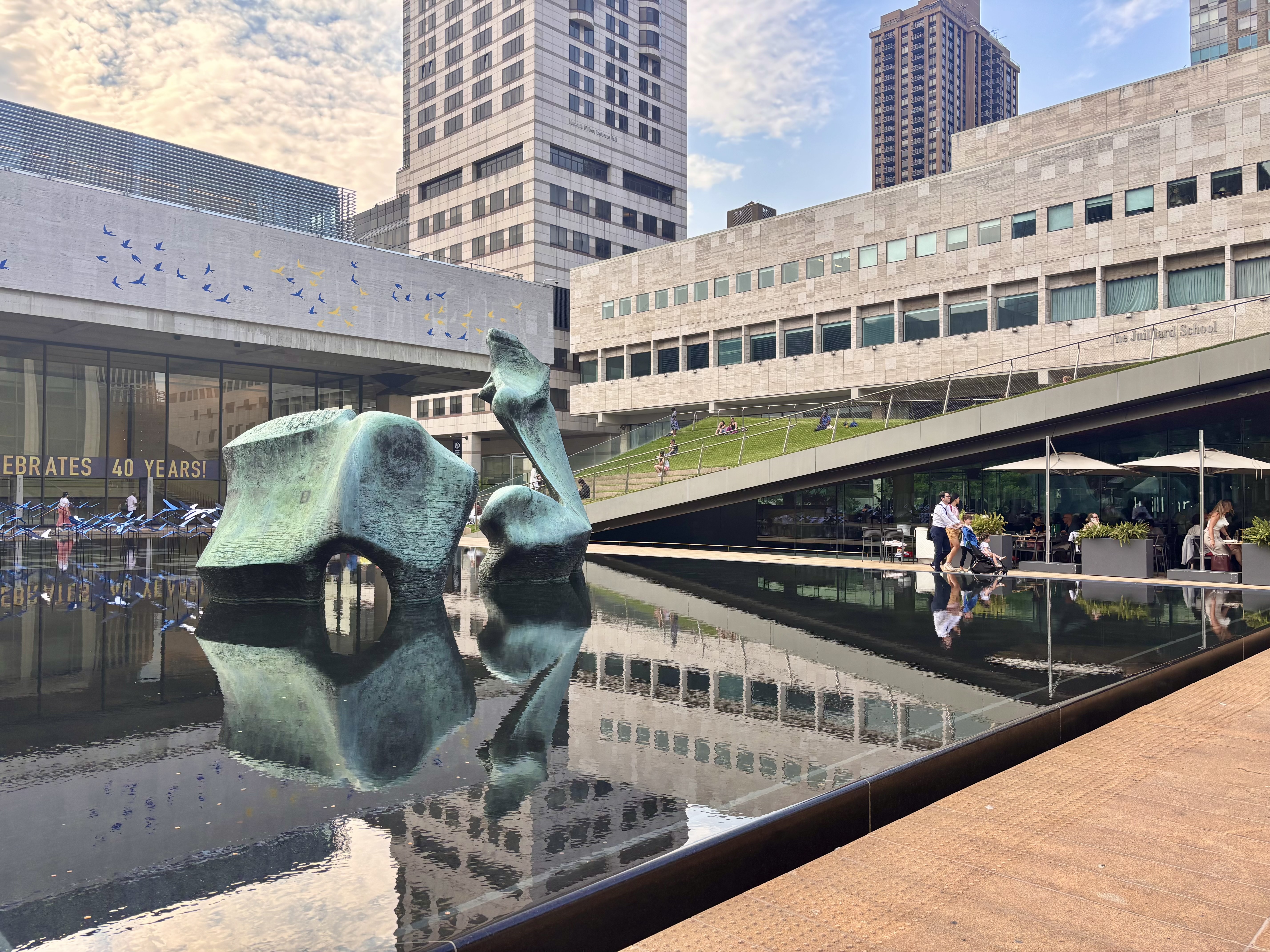 303 West 66th Street, Unit 18EE Manhattan, NY 10023 - Photo 20 of 24 a view of a balcony with two potted plants and wooden fence