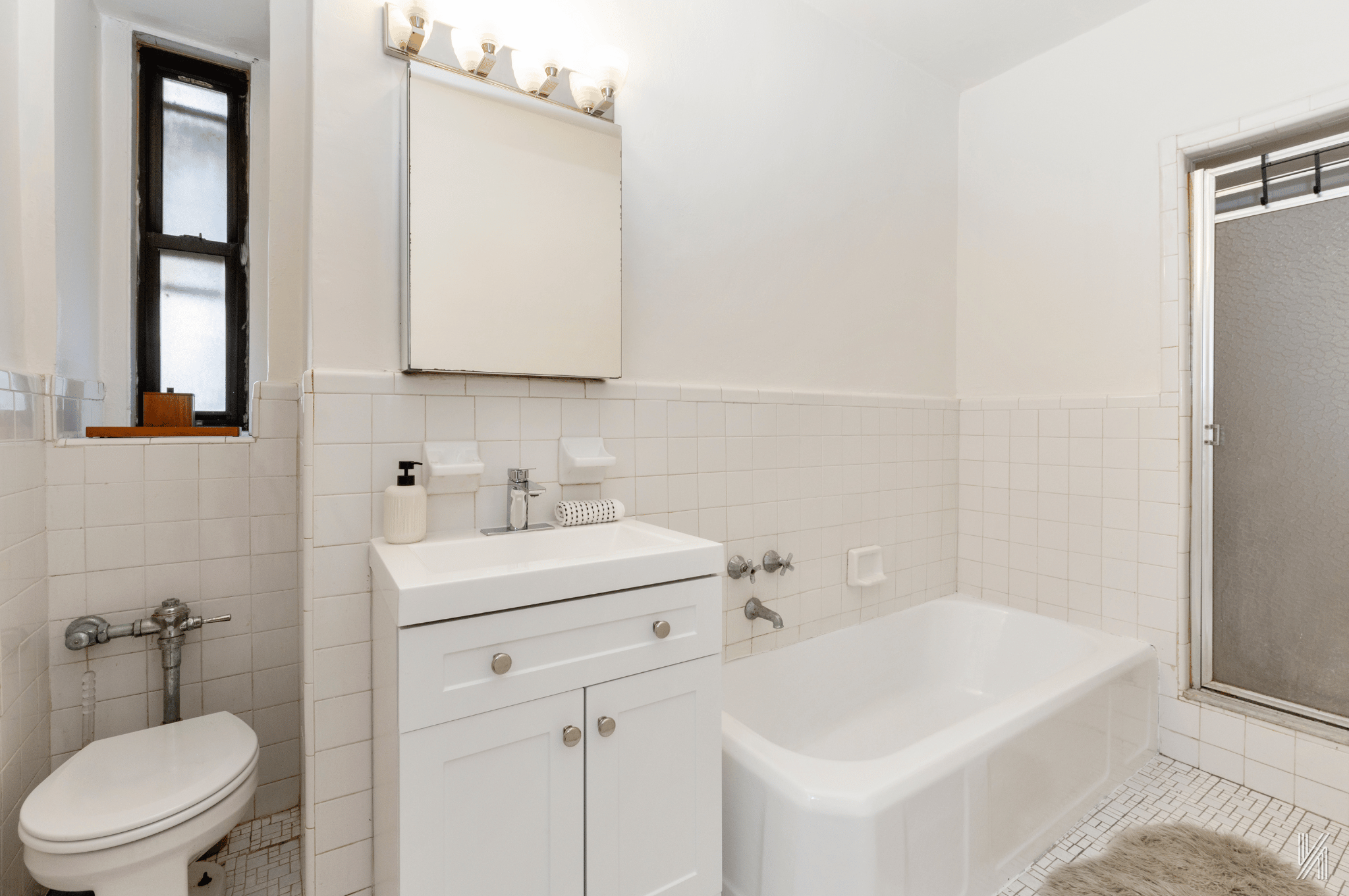35-35 75th Street, Unit 428 Queens, NY 11372 - Photo 17 of 21 a bathroom with a sink a toilet and mirror